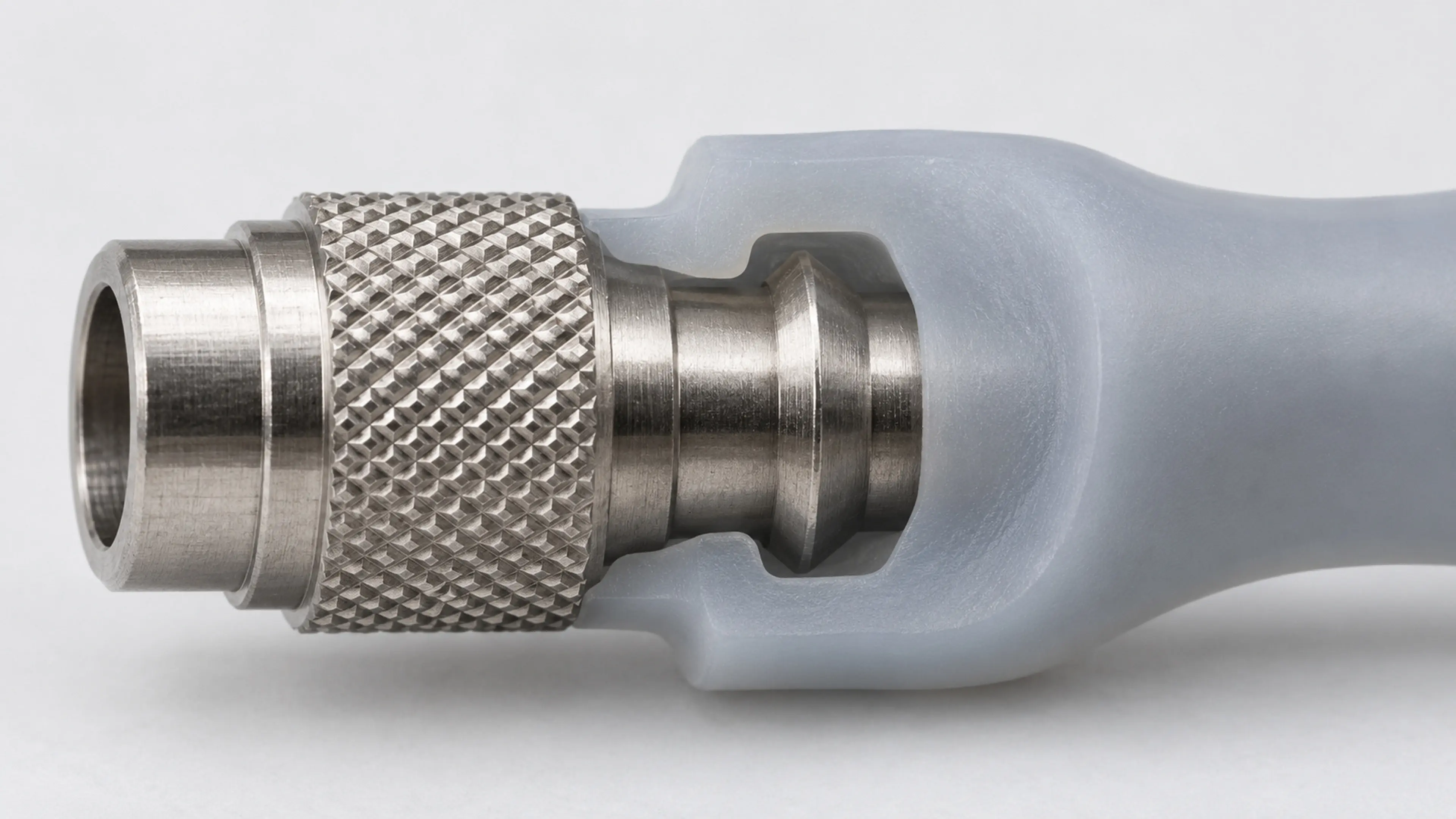 Silicone-overmolded metal pin mounted in a vertical pull-out test fixture.