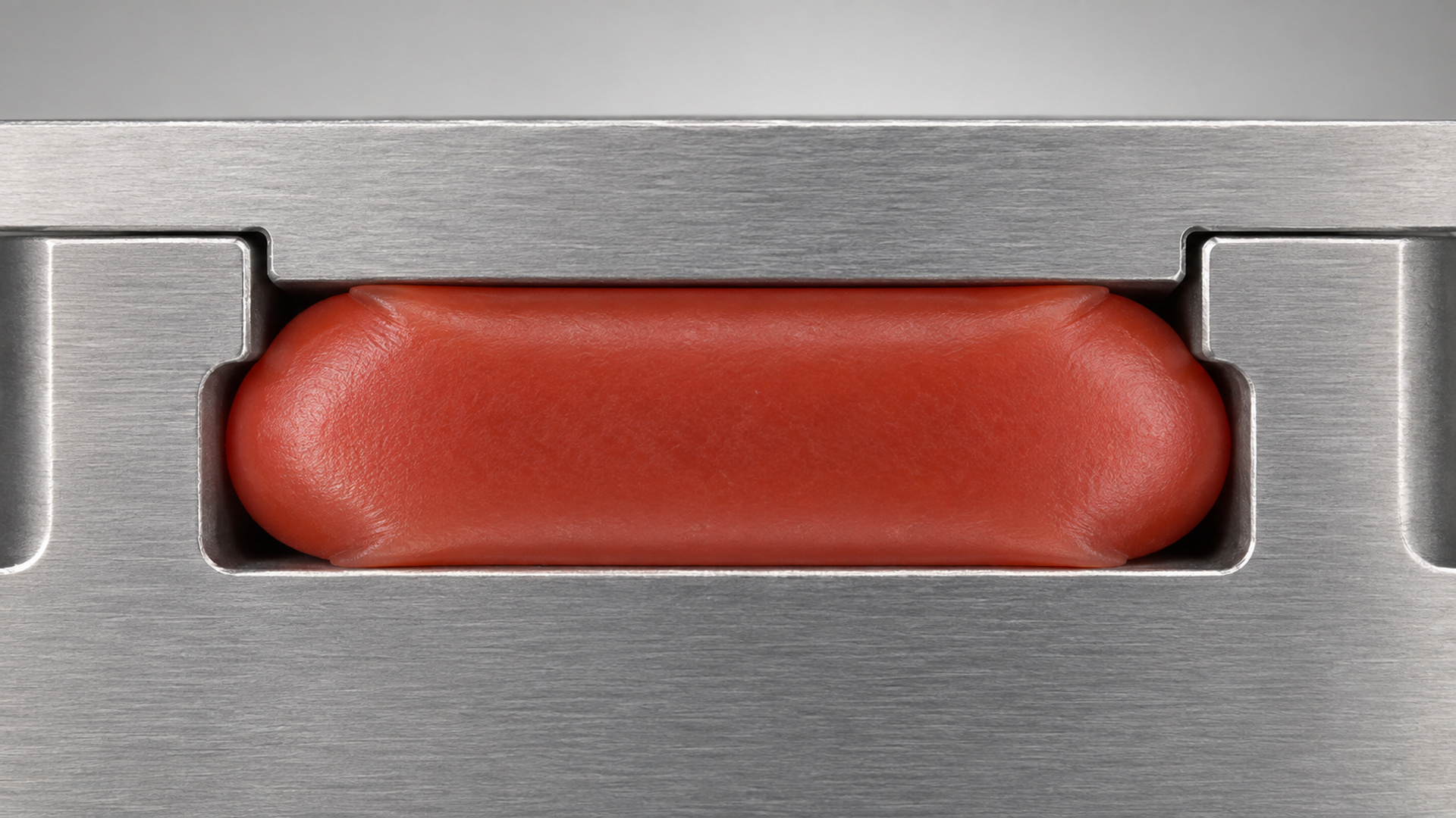 Cross-section of a silicone seal compressed inside a housing groove